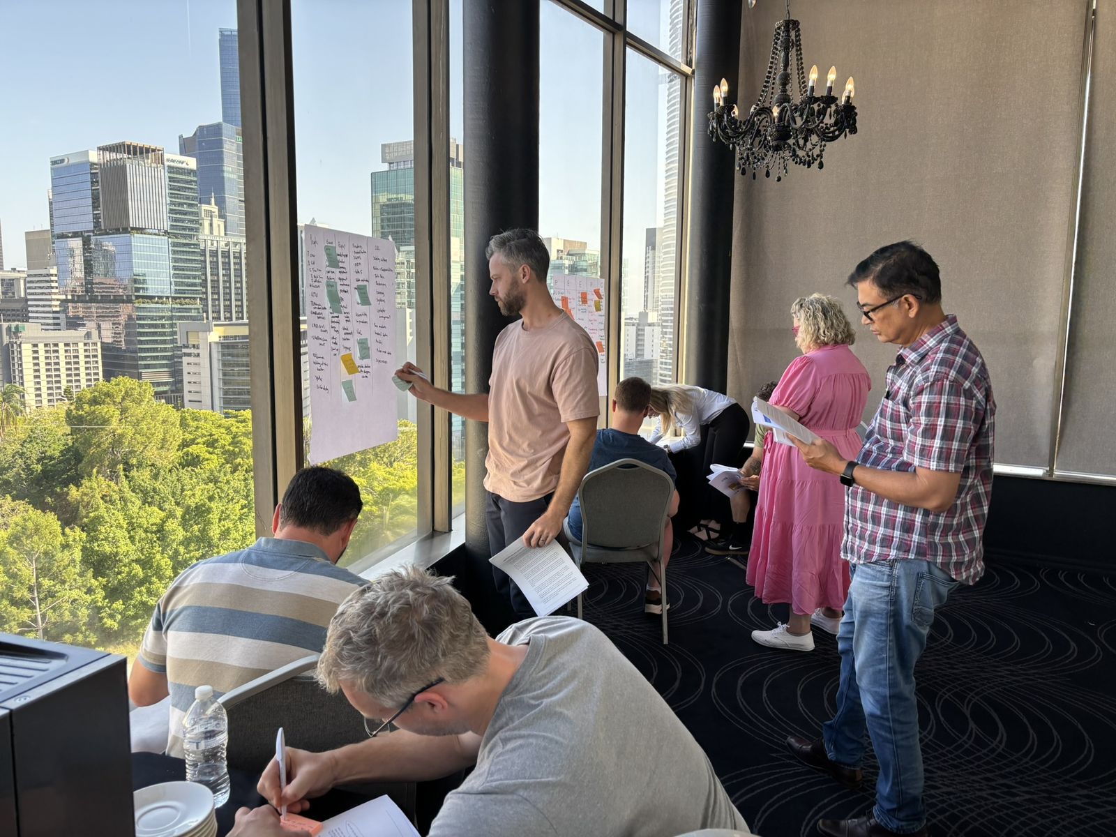 An ICAM Australia course group at the wall charts in Brisbane