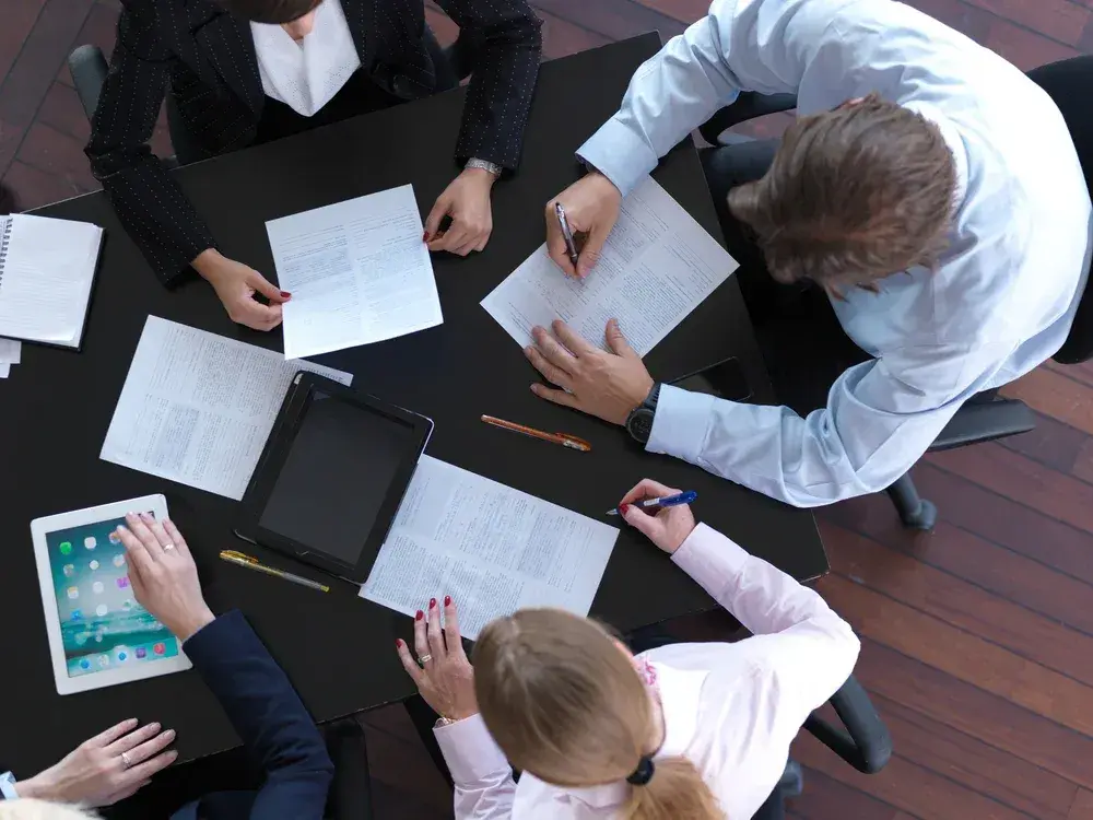 top view of  business people group on meeting, working in modern bright office indoor with tablet computer